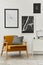 Retro and minimalist compositon of living room interior with design armchair,  mock up poster map, lamp, decoration, white wall