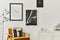 Retro and minimalist compositon of living room interior with design armchair, mock up poster map, lamp, decoration, white wall.