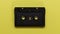 Retro music cassette tapes on yellow background