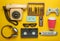 Retro objects on a yellow background. Rotary telephone, audio cassette, video cassette, gamepad, 3d glasses, tv remote