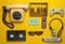 Retro objects on a yellow background. Rotary telephone, audio cassette, video cassette, gamepad, 3d glasses, tv remote