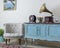 Retro off white armchair and vintage wooden light blue sideboard