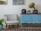 Retro off white armchair, vintage wooden light blue sideboard, old phonograph gramophone and vinyl records