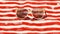 Retro pair of sunglasses on red and white striped beach towel