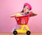Retro parisian woman go shopping with full cart. vintage housewife woman ready to pay in supermarket. savings on