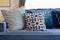 Retro pattern, gray and blue pillow setting up on sofa