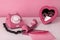 Retro phone with heart mirror and envelopes at table. Still life in pink color. Valentines day concept