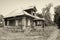 Retro photo with old wooden broken house in russian abandoned vi