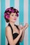 Retro pin up girl spraying perfume with hair rollers