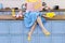 Retro pin up girl woman sitting on kitchen and reading pink cook book