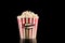 Retro popcorn box in red and white color and full with popcorn