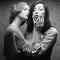 Retro portrait of two gorgeous women (girlfriends) kissing