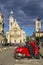 Retro red scooter parked in street near Saint-Etienne-du-Mont is church, Paris France