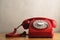 Retro Red Telephone on Light Wood Veneer Table