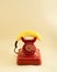 retro red telephone with yellow fresh banana imitating phone handset.communication or invitation concept