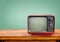 Retro red television on wood table