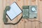 Retro rotary telephone with cable and white empty paper or notebook on wood table, wooden background, top view with copy space, v