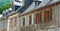 Retro rustic houses with old traditional windows and shutters downtown in picturesque french village in Arreau, France. Panoramic