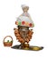 Retro samovar with a bagel and retro doll on it