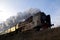 Retro smoky steam locomotive on the former railway line