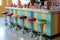 retro soda fountain counter with colorful stools