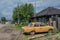 Retro Soviet Yellow Car in Poor village of Bolshoy Balchug in Siberia