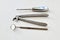 Retro. Steel rare medical tools for teeth removal on white gauze background. Black and white photography