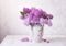 Retro still life with a bouquet of Lilac on a white wooden table. Soft focus