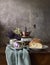 Retro still life poster breakfast. Vintage coffee grinder cups, silver spoon, homemade bread bakery. Dark light, wooden
