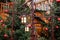 Retro street lanterns and red christmas balls with LED garlands on decorated natural New Year trees on a festive Christmas fair on