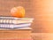 Retro style of apple on stacks of books on wooden table background.