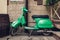 Retro style green scooter on Lviv street. Exterior, restaurant design. Modep left outdoors