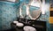 Retro style mirrors, washbasins and soap tank in public toilet room