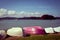 Retro style photo of upturned rowing boats on an empty beach. Bay of Islands, New Zealand. Toned image