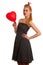 Retro style pin up girl with blonde hair in black dress wtih whi