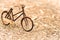 Retro styled image of a nineteenth century bicycle wooden model on a nature background