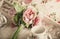 Retro styled photo of pink flowers lying on tray with teacups