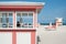 Retro styled pink and white timber kiosk on beach at Miami with