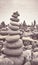 Retro stylized picture of a volcanic stones stack on a beach