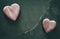 Retro stylized two wooden hearts on cracked stone background.