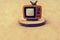 Retro syled tiny television model on brown