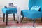 Retro teal armchair and matching ottoman with decor objects horizontal