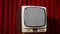 retro television with static against velvet curtain