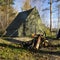 Retro tent in forest and camp fire