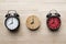 Retro three alarm clocks on wooden table
