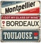 Retro tin sign collection with French cities