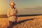 Retro toned image of agronomist farmer using mobile phone