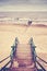 Retro toned picture of stairs on beach.
