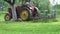 Retro tractor and beehive in old farm spring garden