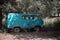 Retro transport recycling scrap metal, utilization, vintage old rusty car uaz abandoned destroyed on the street among